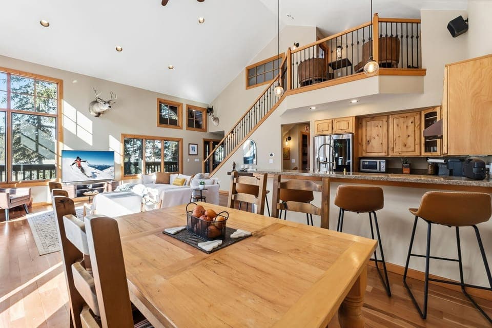 Gather your loved ones in this stunning open-concept space where rustic charm meets modern comfort for memorable mountain retreat moments.