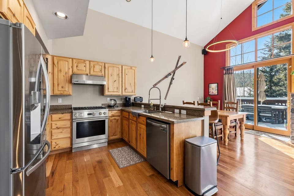 Cook memorable meals in your fully-equipped mountain kitchen with granite counters, stainless appliances, and stunning alpine views through soaring windows.
