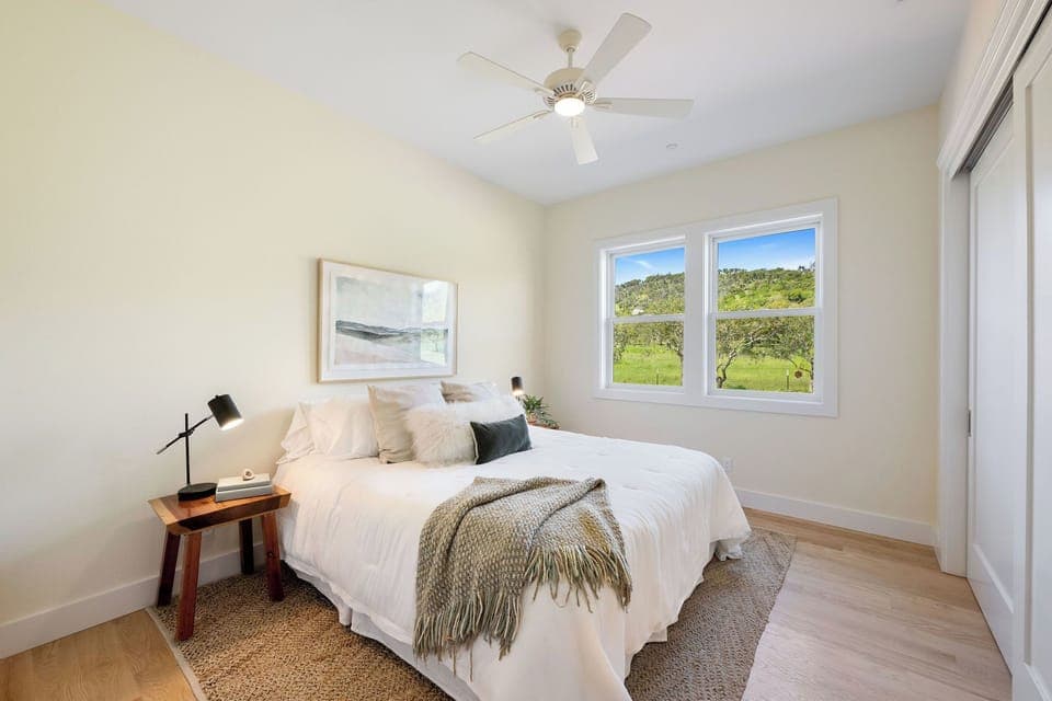 Guest bedroom has views of the olive orchard & hills.