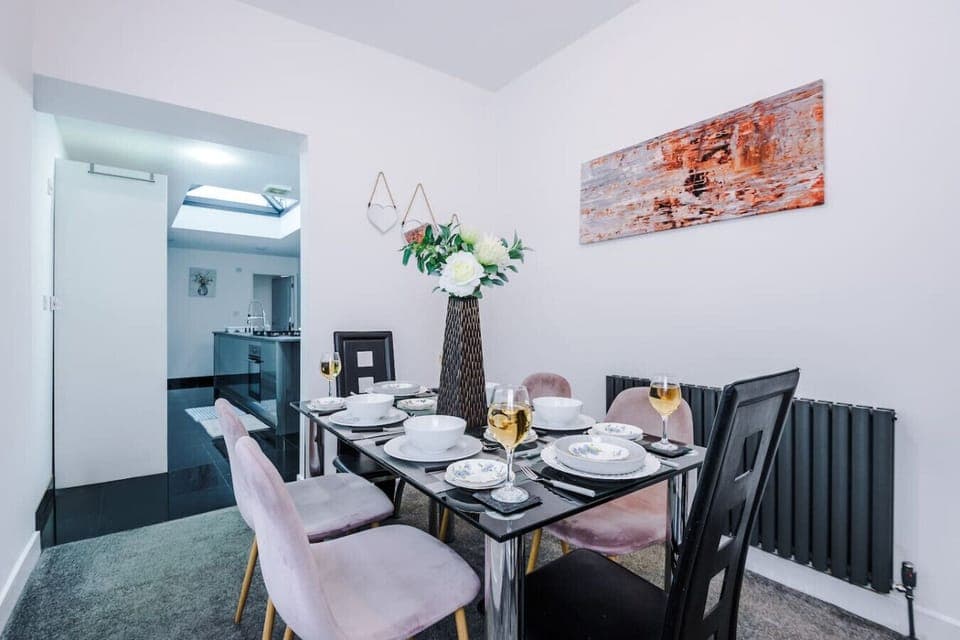 Bedroom view showing multiple beds and a wall-mounted TV.