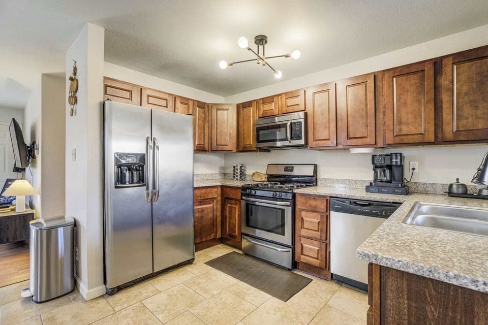 This updated, fully stocked kitchen features granite countertops and professional-grade stainless steel appliances. Deep wood cabinetry and a dedicated coffee station provide a polished and highly functional space for your stay.