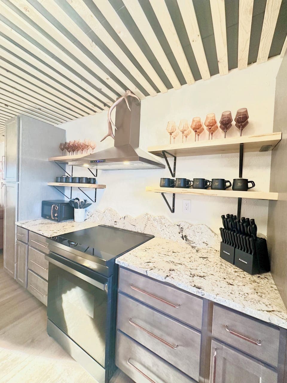 Open shelving with mugs, glasses, and more.