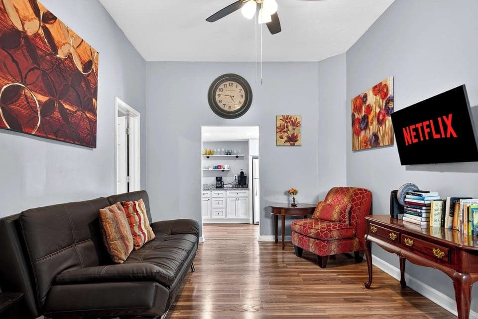 Living Room: Relax in this bright, cozy living room with high ceilings, stylish décor, and a Smart TV ready for your favorite shows—perfect for unwinding after a day exploring Louisville.