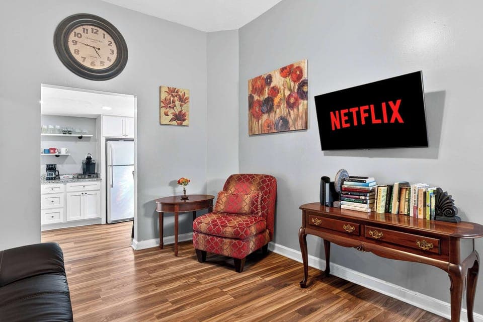 Living Room: Relax in this bright, cozy living room with high ceilings, stylish décor, and a Smart TV ready for your favorite shows—perfect for unwinding after a day exploring Louisville.