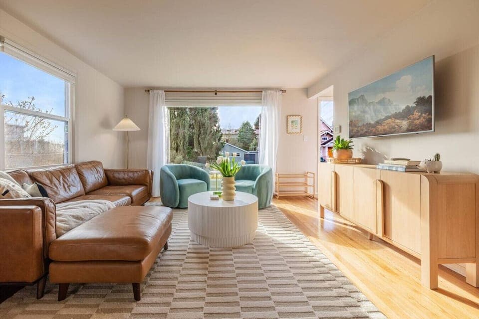 Sun-filled living room with a large picture window showcasing neighborhood views—and on clear days, a beautiful glimpse of Mount Rainier.
