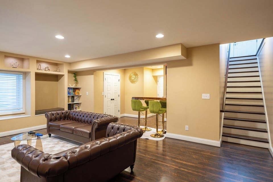 Private Bourbon Lounge with 86″ TV, leather seating & bar