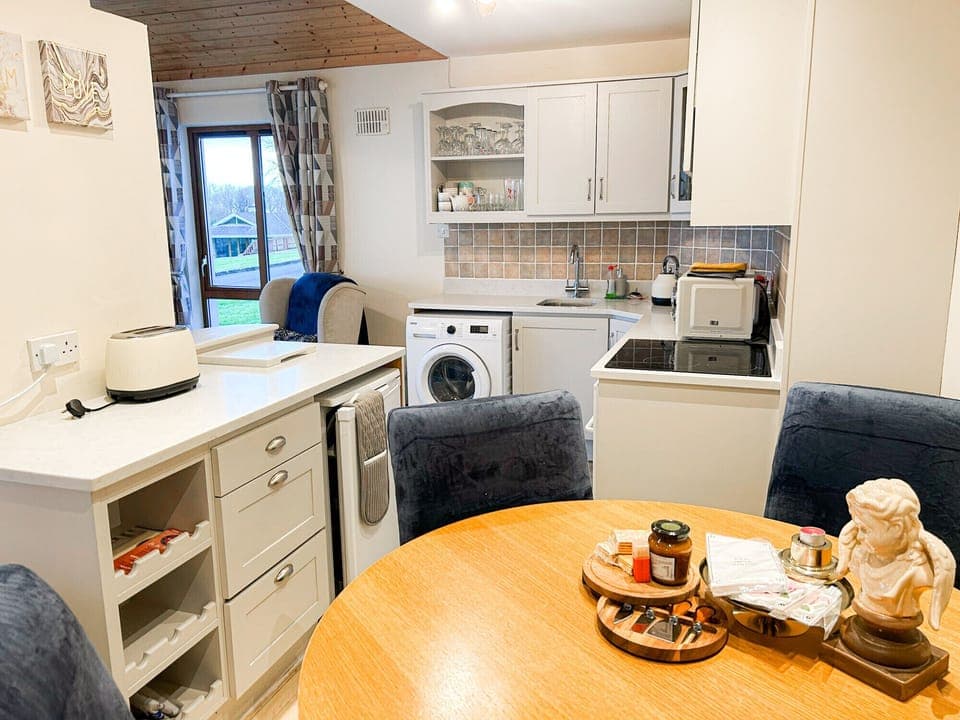 Glasson Mews Holiday Home No. 2. Compact kitchen with dining table.