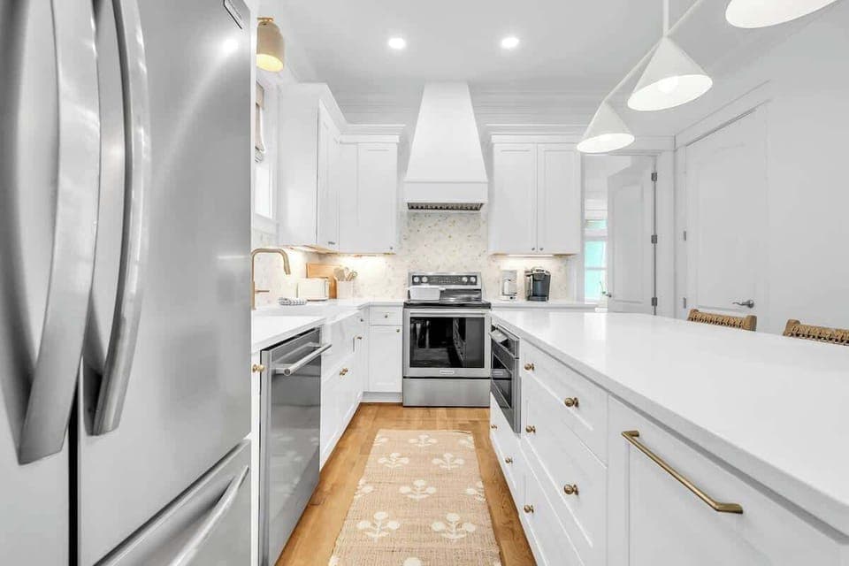 Fully stocked kitchen with a large island and seating for three