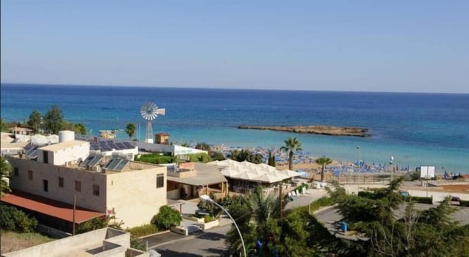 On the beach, white sand, sun loungers, beach umbrellas