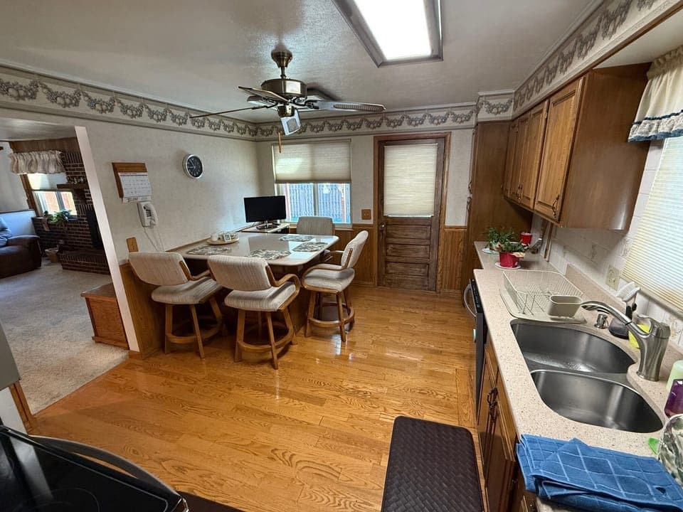 Dining area in kitchen, TV, and door to the back covered patio