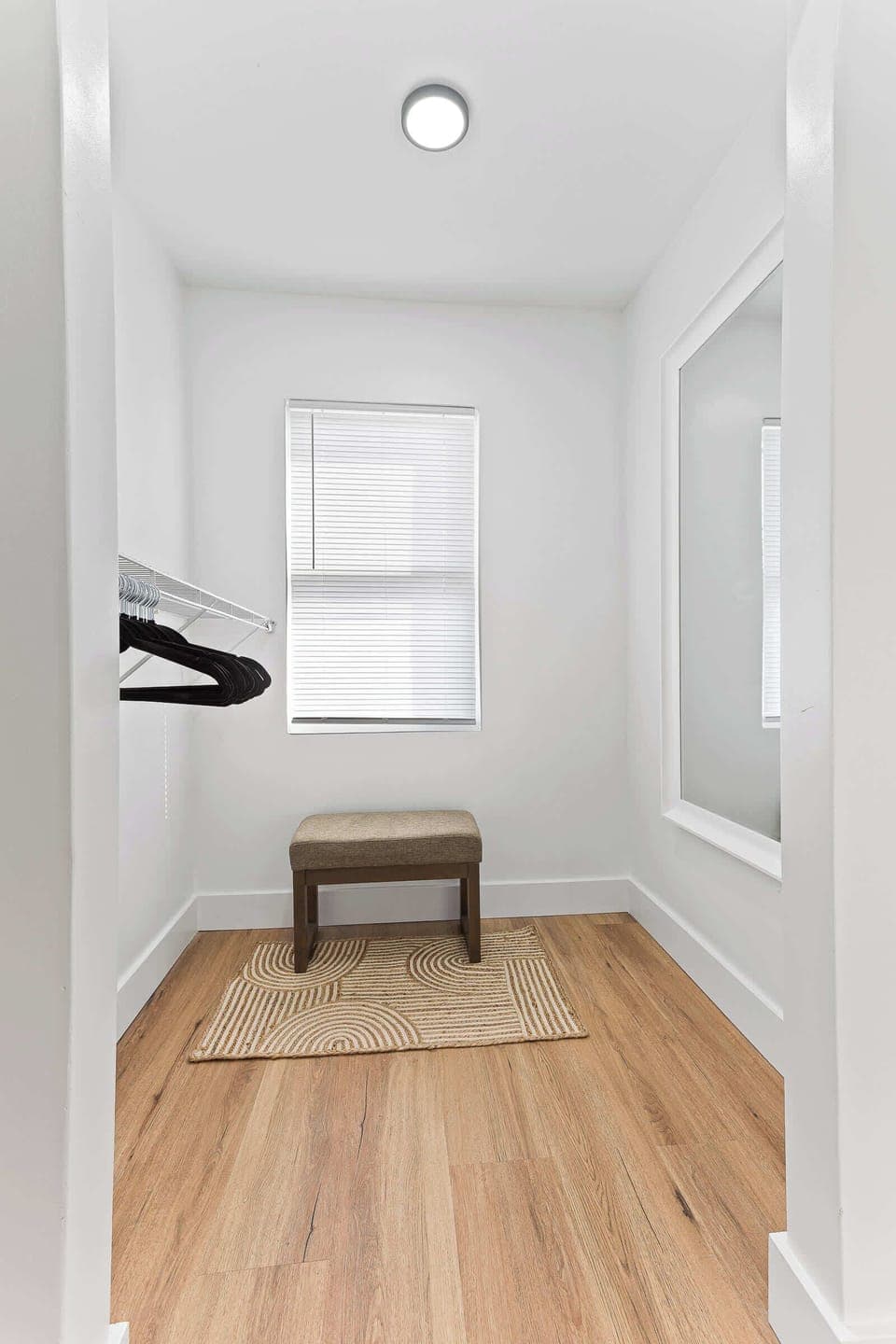 Inviting bedroom entrance with warm wood floors and soft natural light. A calm and comfortable space designed to provide restful nights and a peaceful stay.