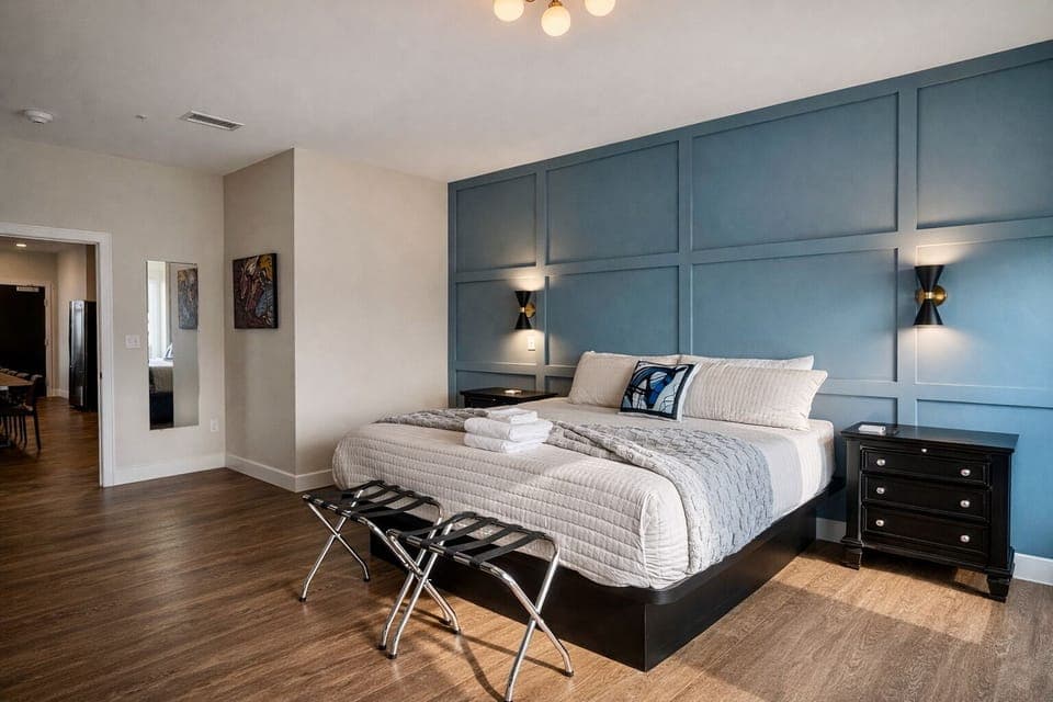 Spread out in this massive suite featuring gorgeous warm wood style flooring and plenty of natural light. The sleek black dresser provides all the storage space you could ever need.