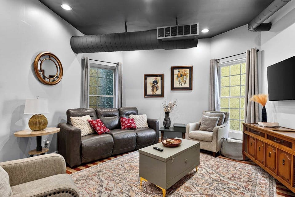 Living Area 1: The living area in Unit 1 offers a warm, inviting space with plush seating and natural light.