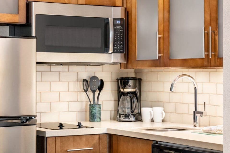 The fully equipped kitchen showcases modern appliances, perfect for preparing meals during your stay.