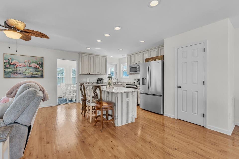 Your spacious open-plan kitchen invites culinary adventures with granite counters, stainless appliances, and a cozy breakfast bar for morning coffee conversations.