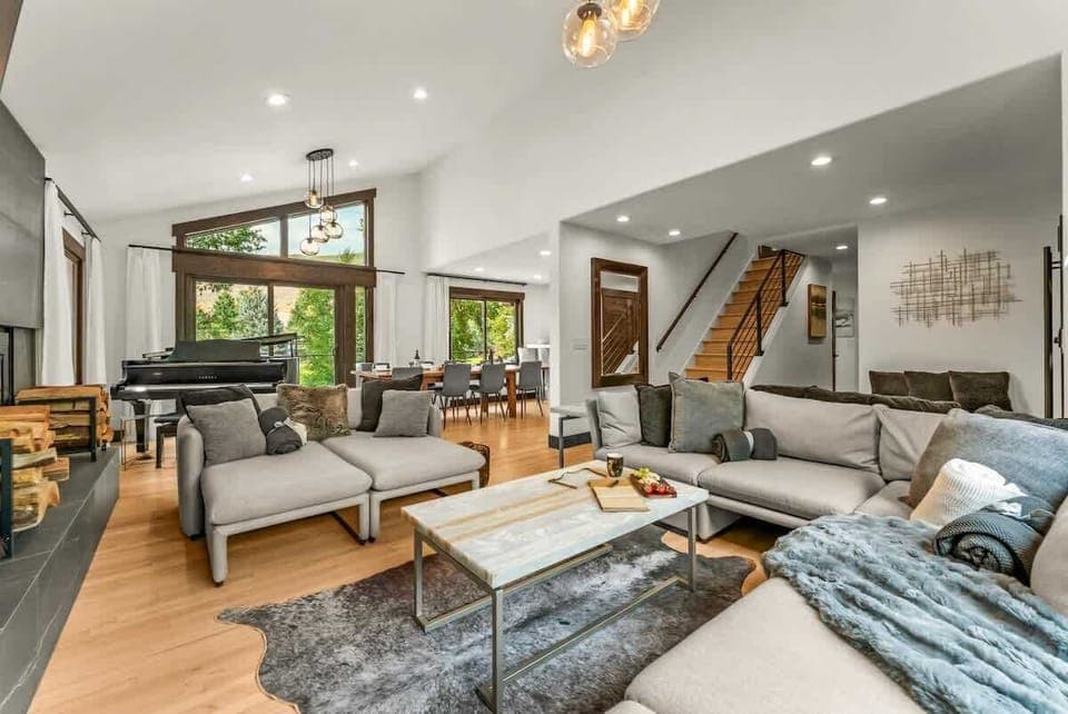 Living room: Wood-burning fireplace, Smart TV, Sonos surround system, piano, main floor