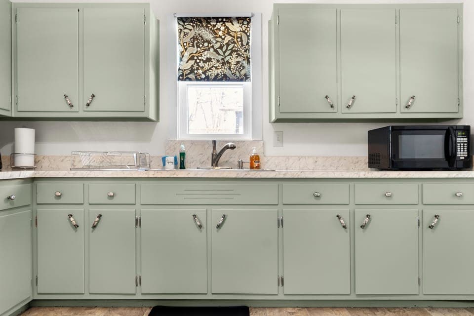 Fully equipped kitchen with ample cabinets for easy home cooking.