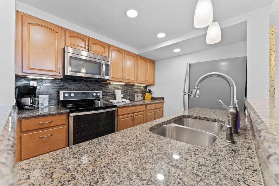 Full kitchen with stainless steel appliances.