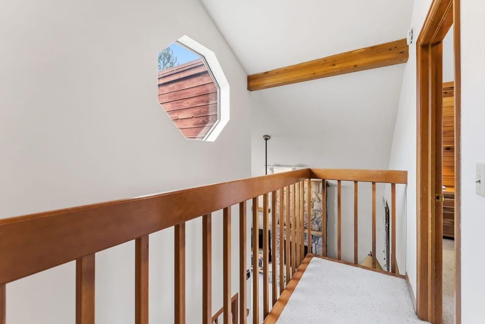 Ascend the charming staircase with warm wood railings and discover the upper level of your retreat.