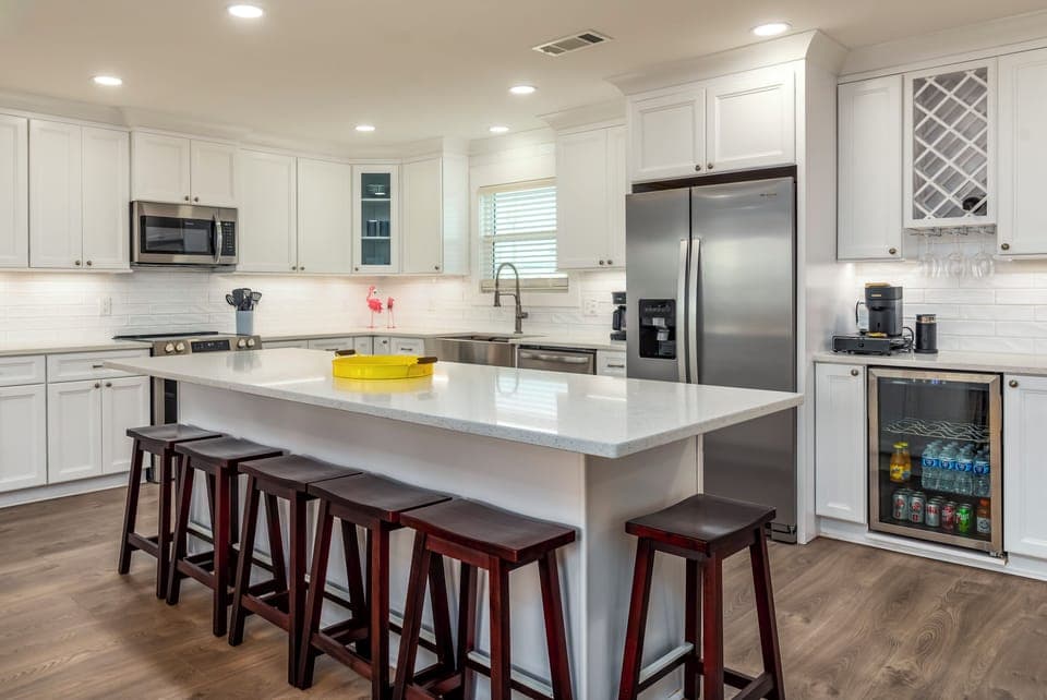 Your gourmet kitchen awaits with gleaming countertops, premium appliances, and a spacious island perfect for preparing meals and gathering together.