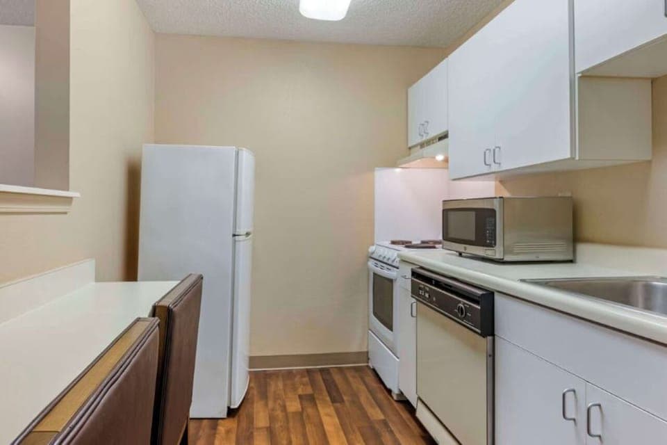 Stock snacks easily with a full fridge and dining counter.