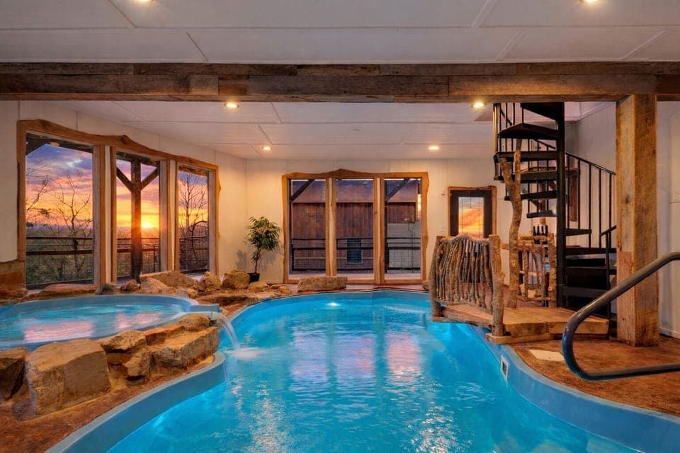 Private indoor pool with a hot tub, waterfall features, and space to unwind year-round. (Aspen Lodge)