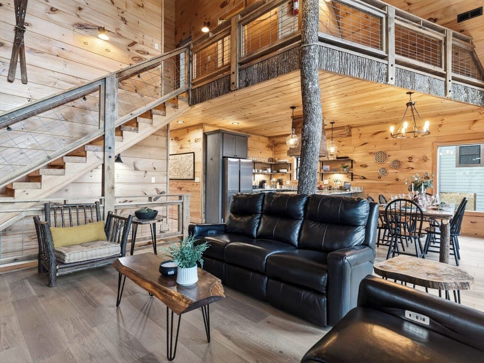Inviting great room with a stone fireplace and comfortable seating for gathering together. (Aspen Lodge)