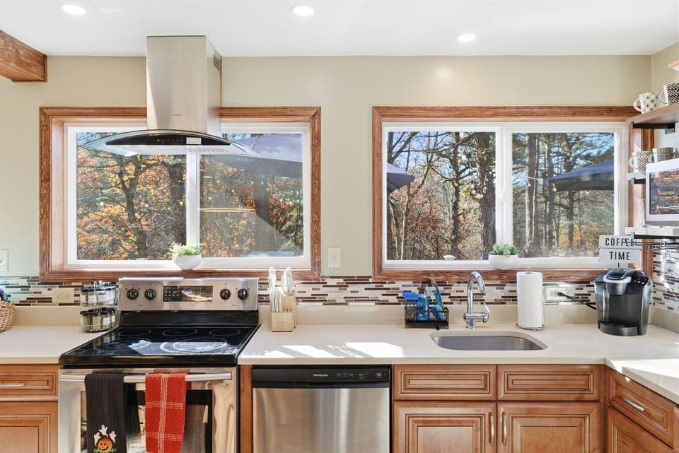 Fully equipped kitchen with modern appliances and cookware.