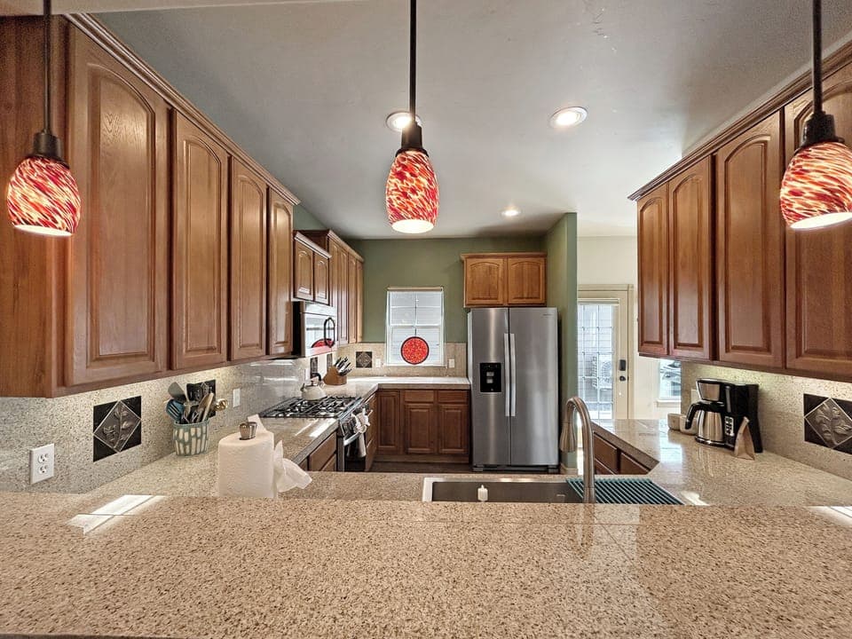Your gourmet kitchen features rich wood cabinets, granite countertops, and stainless steel appliances, creating the perfect space for culinary adventures.