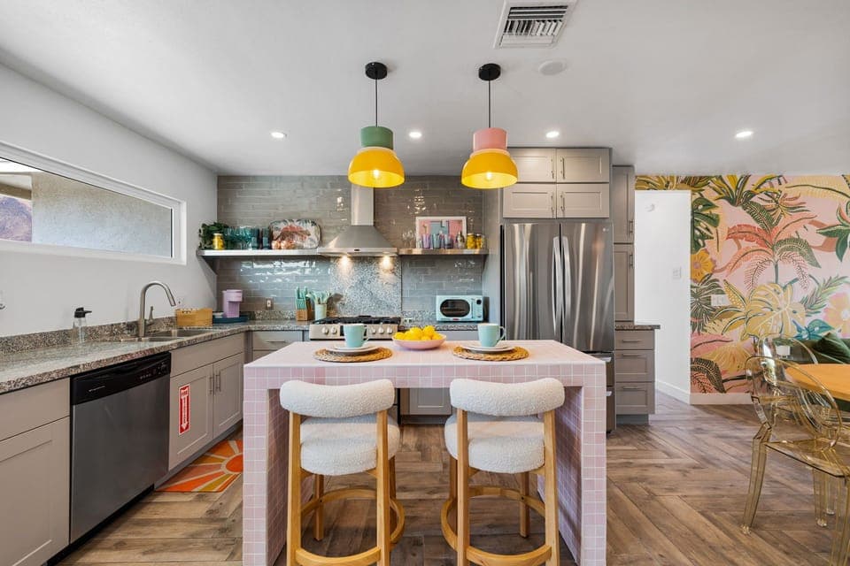 Fully equipped kitchen with island, bar seating & natural light
