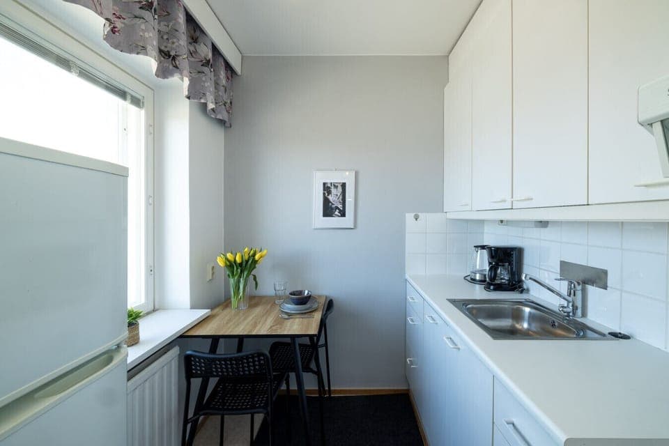 A bright and functional kitchen featuring a cozy dining nook by the window.