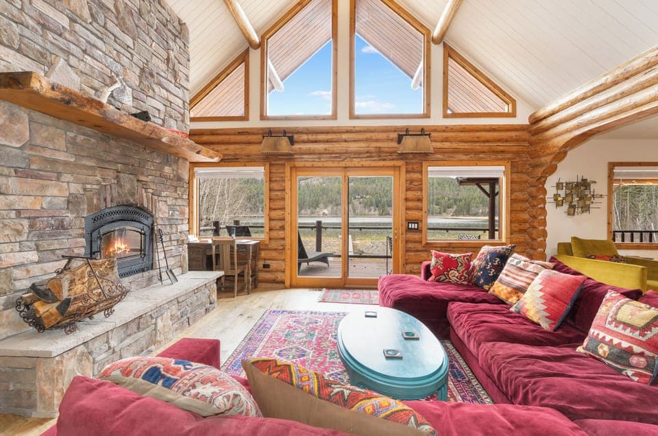 Unwind by your crackling fireplace while soaking in mountain views through floor-to-ceiling windows in this cozy living space.