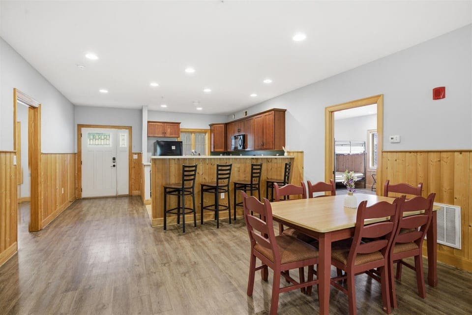 In Unit 711, the dining area flows effortlessly with nearby bar seating, giving everyone a place to sit, connect, and stay part of the moment.