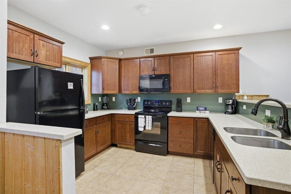 The kitchen in Unit 711 sets the tone for your stay—open, spacious, and ready for everything from quick breakfasts to full meals shared with your group.