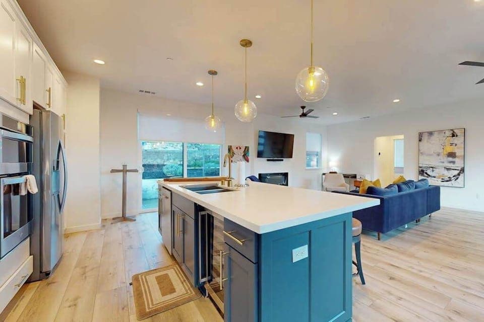 Cook like a local in your gourmet kitchen with stainless double ovens, French-door fridge, and a spacious blue island — perfect after visiting Glen Ellen's farm stands.