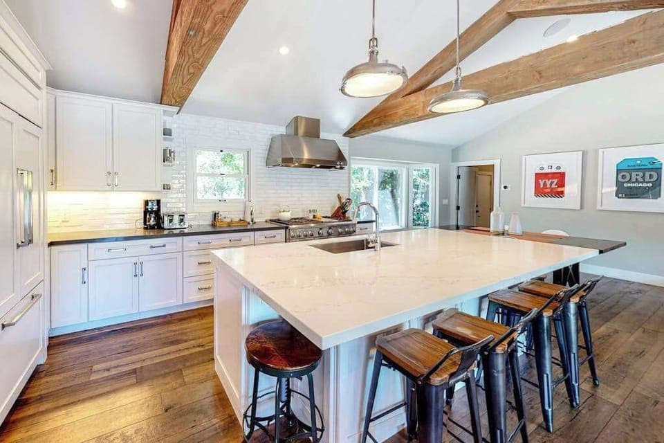 Channel your inner vintner chef at this sprawling quartz island with bar seating — a professional hood and subway tile backsplash complete your Sonoma kitchen.