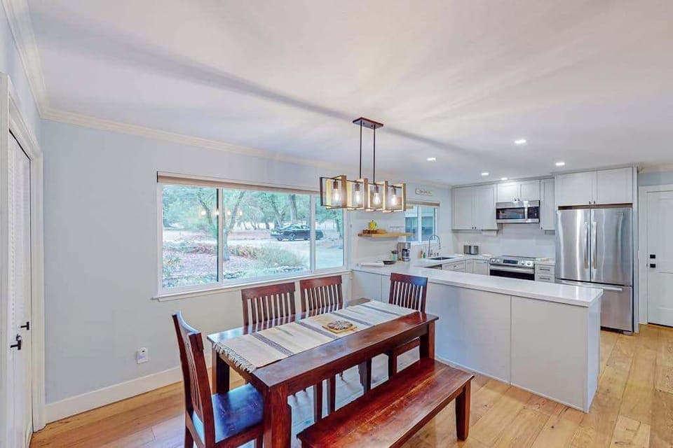 Share a bottle from your Sonoma Valley tastings at the farmhouse-style dining table with bench seating for six, illuminated by a stylish pendant light.