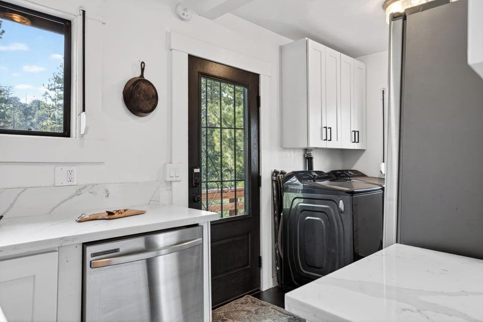 Functional mudroom and laundry area with high-efficiency appliances and direct outdoor access.