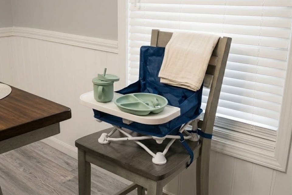 Portable highchair / play seat with toddler / infant utensils.