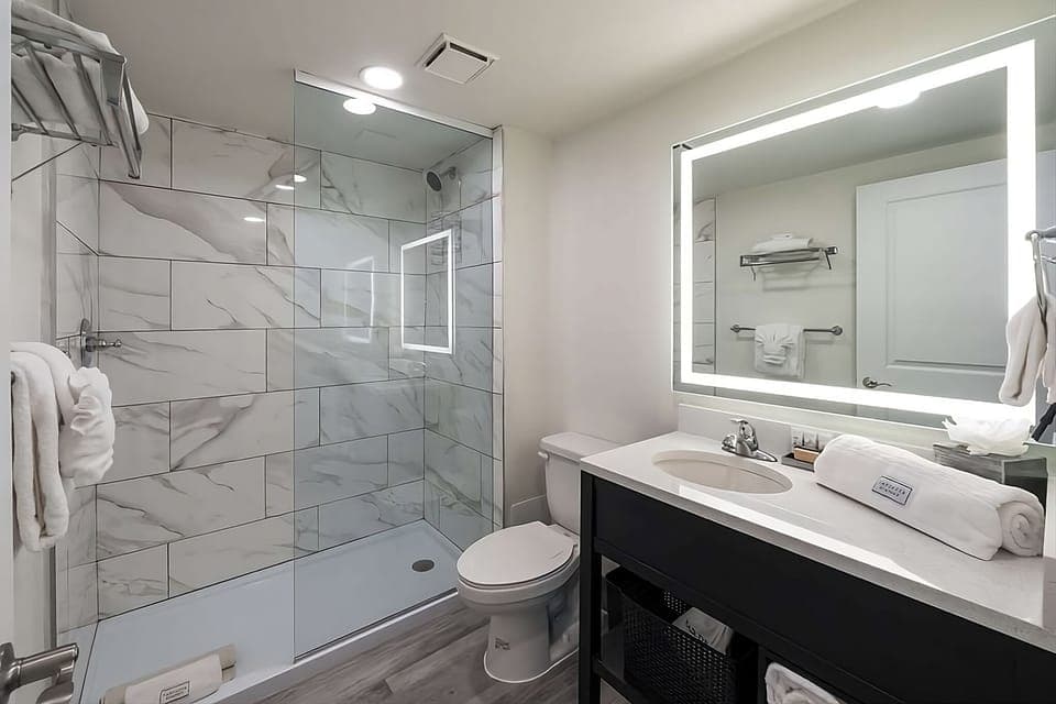 Refresh easily in a spotless bath with glass walk-in shower.