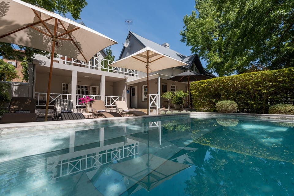 Outdoor pool, a waterfall pool, pool umbrellas, sun loungers
