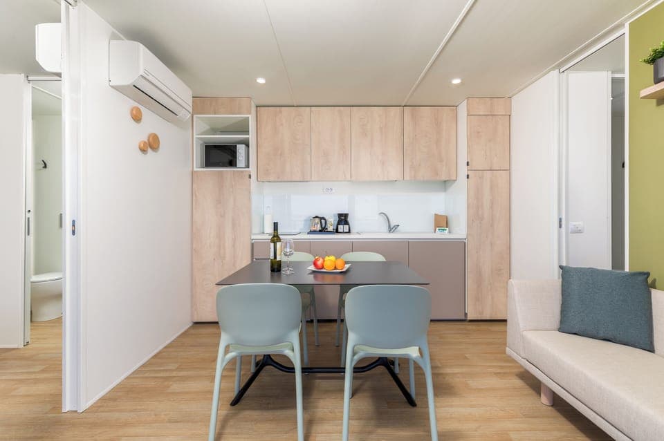 Full-size fridge, stovetop, electric kettle, cookware/dishes/utensils