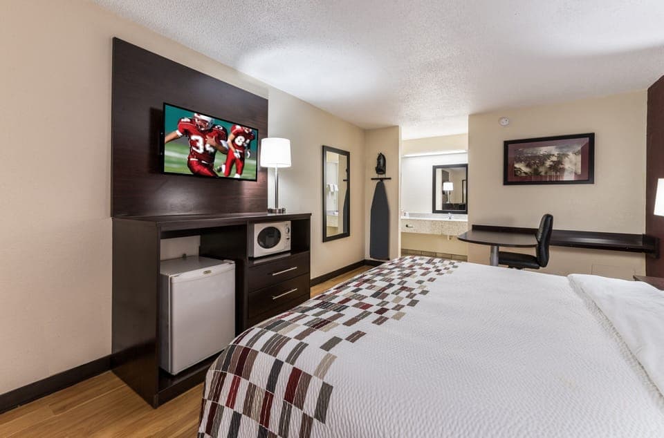 Desk, laptop workspace, blackout drapes, iron/ironing board