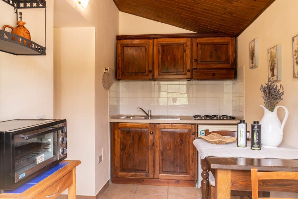 Apartment, 1 Bedroom (Olivo D) | Private kitchen | Full-size fridge, stovetop, electric kettle, highchair