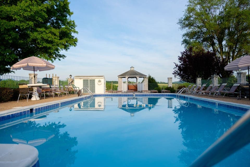 Outdoor pool, open 9:00 AM to 9:00 PM, pool umbrellas