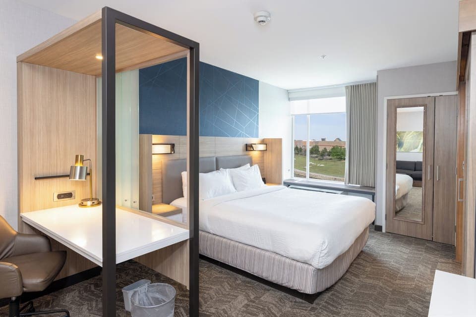 Premium bedding, desk, laptop workspace, blackout drapes