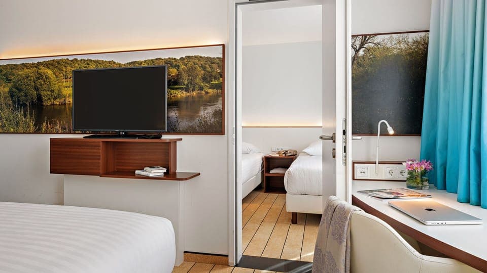 Family Room | Hypo-allergenic bedding, desk, laptop workspace, blackout drapes