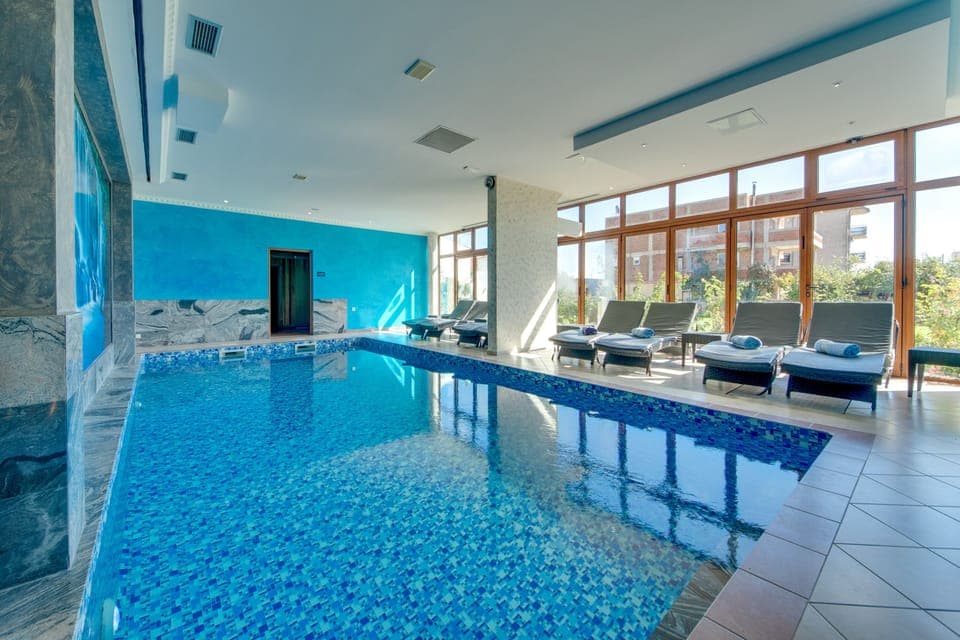 Indoor pool, outdoor pool, pool umbrellas, sun loungers