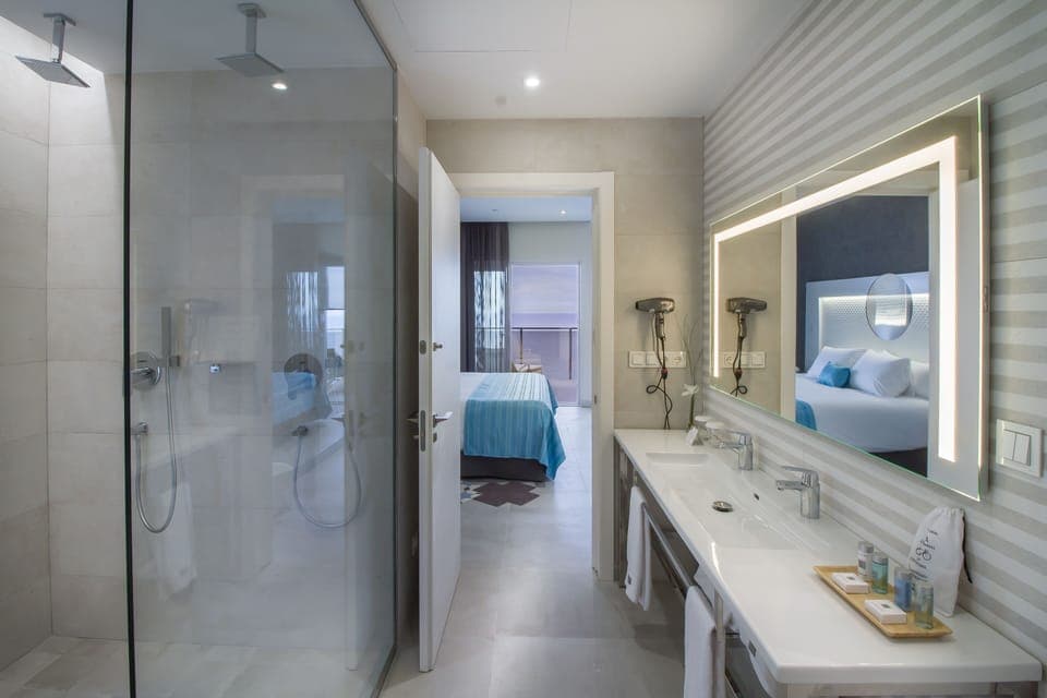 Designer toiletries, hair dryer, slippers, towels