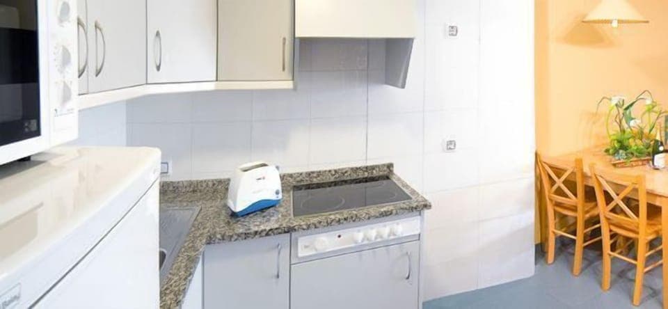 Fridge, microwave, coffee/tea maker, cookware/dishes/utensils
